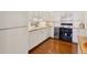 Bright kitchen with white cabinets, granite countertops, and stainless steel appliances, ideal for cooking and entertaining at 5055 Gulf Of Mexico Dr # 422, Longboat Key, FL 34228