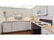 Well-equipped kitchen with white cabinets, granite countertops, and stainless steel appliances, perfect for culinary enthusiasts at 5055 Gulf Of Mexico Dr # 422, Longboat Key, FL 34228