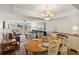 Bright living room with dining area features an open floor plan with views of the balcony at 5055 Gulf Of Mexico Dr # 422, Longboat Key, FL 34228