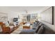 Bright living room features a comfortable sectional, stylish accent chairs, and access to the balcony at 5055 Gulf Of Mexico Dr # 422, Longboat Key, FL 34228