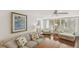 Bright living room with hardwood floors, ceiling fan, comfortable furniture, decor and lots of windows at 5055 Gulf Of Mexico Dr # 422, Longboat Key, FL 34228