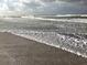 Waves crashing on a sandy beach at 5055 Gulf Of Mexico Dr # 422, Longboat Key, FL 34228