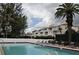 Inviting community pool with lounge chairs and well-maintained landscaping by the condominiums at 5055 Gulf Of Mexico Dr # 422, Longboat Key, FL 34228