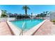 Community pool area with clear water, poolside furniture, and lush landscaping at 5055 Gulf Of Mexico Dr # 422, Longboat Key, FL 34228