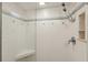 Tiled shower with glass door, built-in seat, shower head and tiled trim, providing a clean and modern showering space at 5055 Gulf Of Mexico Dr # 422, Longboat Key, FL 34228