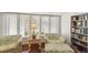 Relaxing sitting area filled with natural light and a built-in bookshelf at 5055 Gulf Of Mexico Dr # 422, Longboat Key, FL 34228