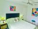 Relaxing bedroom featuring a cozy bed with stylish lamps and artwork at 5061 Barrington Cir # 1302, Sarasota, FL 34234