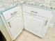 Corner of a kitchen featuring white cabinets with modern hardware at 5061 Barrington Cir # 1302, Sarasota, FL 34234