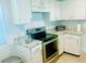 Bright kitchen featuring stainless steel appliances and white cabinetry at 5061 Barrington Cir # 1302, Sarasota, FL 34234