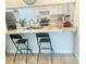 Kitchen bar with granite countertop, modern sink, and appliances at 5061 Barrington Cir # 1302, Sarasota, FL 34234