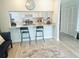 Kitchen bar with modern countertop, sink, and kitchen appliances at 5061 Barrington Cir # 1302, Sarasota, FL 34234