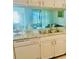 Kitchen showcasing stainless steel sink, granite countertops, and white cabinetry at 5061 Barrington Cir # 1302, Sarasota, FL 34234