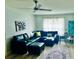 Spacious living room with dark sofa, modern fan and neutral decor at 5061 Barrington Cir # 1302, Sarasota, FL 34234