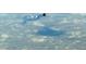 A turtle swims in a pond, creating ripples through the clear, reflective water at 5061 Barrington Cir # 1302, Sarasota, FL 34234