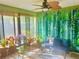 Bright sunroom with natural light, an abundance of plants, and a relaxing seating area at 5061 Barrington Cir # 1302, Sarasota, FL 34234