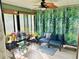 Bright sunroom featuring large windows, ample plants, and a comfortable seating area at 5061 Barrington Cir # 1302, Sarasota, FL 34234