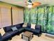 Comfortable sunroom featuring a fan and ample seating with a tropical backdrop at 5061 Barrington Cir # 1302, Sarasota, FL 34234