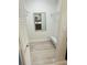 Bright walk-in closet features white wire shelving, seating and view of bath area through mirror at 5061 Barrington Cir # 1302, Sarasota, FL 34234