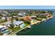 Waterfront home featuring a private dock, lush landscaping, and a sparkling pool, perfect for luxurious outdoor living at 527 Key Royale Dr, Holmes Beach, FL 34217