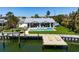 Stunning waterfront home featuring a private dock, swimming pool, and lush landscaping at 527 Key Royale Dr, Holmes Beach, FL 34217