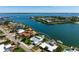 Aerial view of a waterfront property with lush landscaping, a private dock, a boat lift, and stunning water views at 527 Key Royale Dr, Holmes Beach, FL 34217