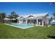Beautiful backyard with a sparkling pool, lounge chairs, and a covered outdoor dining area at 527 Key Royale Dr, Holmes Beach, FL 34217