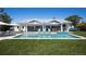 A refreshing pool with cozy lounge chairs and outdoor seating, perfect for enjoying sunny days and relaxation at 527 Key Royale Dr, Holmes Beach, FL 34217
