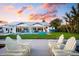 Stunning backyard with a pool, outdoor seating, and waterfront views, creating a serene and luxurious outdoor living space at 527 Key Royale Dr, Holmes Beach, FL 34217