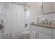 This full bathroom has a shower and tub combo, white vanity, and is brightly lit at 527 Key Royale Dr, Holmes Beach, FL 34217