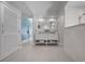 Bright bathroom boasts a double vanity with marble countertops and tile floors at 527 Key Royale Dr, Holmes Beach, FL 34217