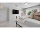 Bright bedroom with a large television mounted to the wall and white tile floors at 527 Key Royale Dr, Holmes Beach, FL 34217