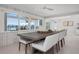 Bright dining room with large windows overlooking the water and a modern table and chairs at 527 Key Royale Dr, Holmes Beach, FL 34217