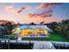 Beautifully landscaped home featuring a private dock, pool, and outdoor dining area at 527 Key Royale Dr, Holmes Beach, FL 34217
