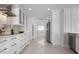Stylish kitchen featuring white cabinetry, stainless steel appliances, and an open layout for easy entertaining at 527 Key Royale Dr, Holmes Beach, FL 34217