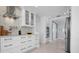 Modern kitchen featuring sleek appliances, white cabinets, and tiled backsplash at 527 Key Royale Dr, Holmes Beach, FL 34217