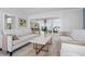 Elegant living room showcasing sophisticated decor, a view into the dining area, and open-concept living at 527 Key Royale Dr, Holmes Beach, FL 34217