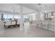 Open-concept living space with dining area, bar seating, and views of the waterfront at 527 Key Royale Dr, Holmes Beach, FL 34217