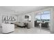 Bright living room with water views, featuring white wood paneling and sliding glass doors to the outdoors at 527 Key Royale Dr, Holmes Beach, FL 34217