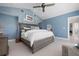Serene bedroom features blue walls, neutral-toned furnishings, and vaulted ceilings for an airy feel at 527 Key Royale Dr, Holmes Beach, FL 34217