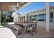 An outdoor dining area includes a large table and views of the yard and waterway at 527 Key Royale Dr, Holmes Beach, FL 34217