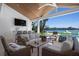 Inviting covered patio with comfortable seating, wet bar, and waterfront views at 527 Key Royale Dr, Holmes Beach, FL 34217