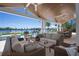 Spacious outdoor living area with comfortable seating, dining area, and pool overlooking the water at 527 Key Royale Dr, Holmes Beach, FL 34217