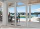 Expansive patio with views of the pool and waterfront, accessible through sliding glass doors from inside at 527 Key Royale Dr, Holmes Beach, FL 34217