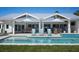 This back patio features a pool, lounge chairs, and outdoor seating area at 527 Key Royale Dr, Holmes Beach, FL 34217
