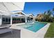 Enjoy swimming in this spacious pool, with views of the lush backyard and waterway at 527 Key Royale Dr, Holmes Beach, FL 34217
