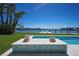 Beautiful pool with a view of the bay and lush green lawn at 527 Key Royale Dr, Holmes Beach, FL 34217