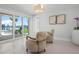 Bright sitting area with water view, plush chairs, and stylish lighting fixture at 527 Key Royale Dr, Holmes Beach, FL 34217