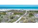 Aerial view of a sandy beach with people enjoying the sunny weather and turquoise water at 5300 Ocean Blvd # 202, Sarasota, FL 34242