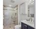 Well-lit bathroom featuring tiled glass shower, tile flooring and backsplash and a white vanity at 5300 Ocean Blvd # 202, Sarasota, FL 34242