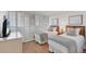 A cozy bedroom features twin beds, shuttered windows, and minimalist decor for a peaceful retreat at 5300 Ocean Blvd # 202, Sarasota, FL 34242